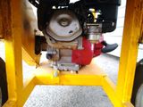 a close up of a small engine on a yellow stand