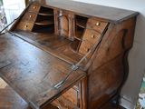 a wooden desk with a drawer on top of it