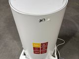 a white trash can sitting on the floor in a warehouse