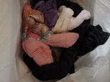 a bag full of clothes that is sitting on the floor