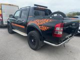 a black truck with orange flames painted on it