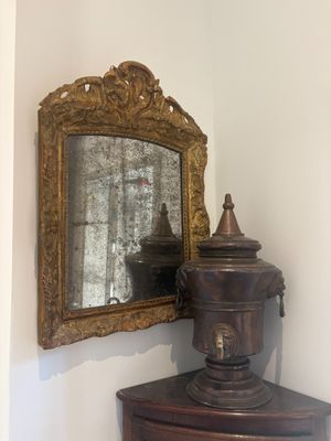 a mirror on the wall next to a wooden cabinet