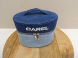 a blue hat with a zipper on it sitting on top of a wooden table