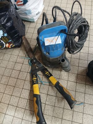 a pair of scissors and a pair of pliers on the floor