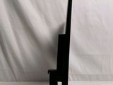 a black sculpture of a knife on a stand