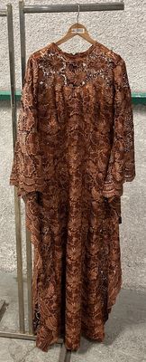 dress hanging on a rack in front of a white wall