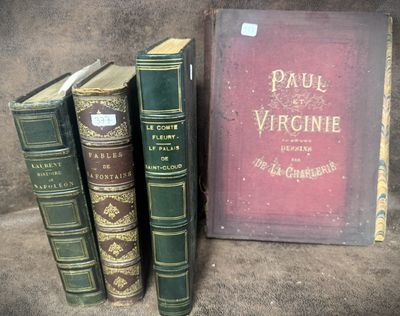 several old books are sitting on a table next to a book