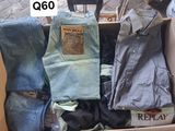 a cardboard box full of jeans and a pair of shoes