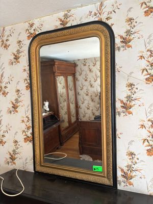 a mirror that is sitting on a dresser in a room