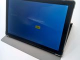 a tablet with a blue screen sitting on top of a table
