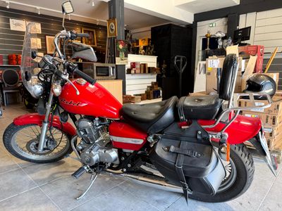 a red motorcycle that is parked in a garage