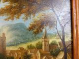 un tableau représentant un village avec une église en arrière-plan