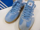 blue and white adidas trainers with gum soles on a table