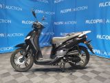 a scooter that is parked in front of a blue wall