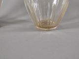 two glass vases that are sitting on a table