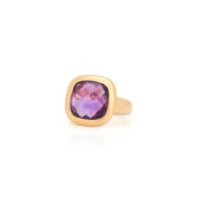 a close up of a gold ring with a purple stone