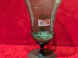 an image of a glass vase sitting on top of a red surface