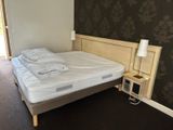 a bed with a white sheet on it in a room