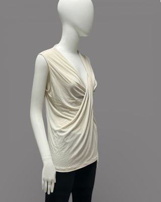 an image of a mannequin wearing a white top and black pants