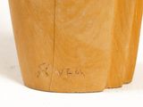 a close up of a wooden stool with writing on it