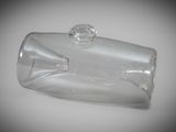 a clear glass bottle with a stopper sitting on a table