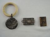 three pieces of jewelry including a ring, a ring, and a pendant