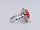 a close up of a ring with a red stone in it