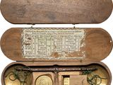 an old wooden box with a clock inside of it