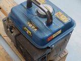 a small blue engine on a pallet on a wooden pallet