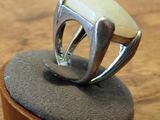 a ring that is sitting on top of a wooden stand