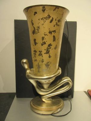 a gold vase that is sitting on a table