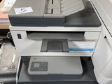 a printer sitting on top of a desk next to a computer