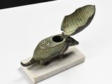 statue of a turtle with a shell on its back on a marble base