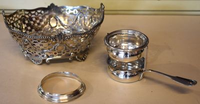 a silver bowl and a spoon sitting on a table