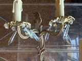 two candles that are sitting on a clear shelf