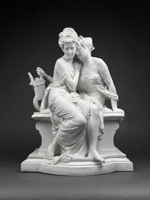 a black and white photo of a statue of two women sitting on a bench