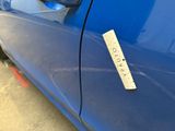 a sticker on the door of a blue car