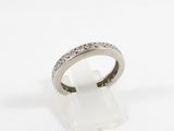 a close up of a diamond ring on a white surface