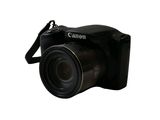 a black camera that is sitting on a white surface