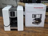 two coffee machines sitting next to each other on a table