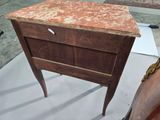 a small wooden table with a marble top on display