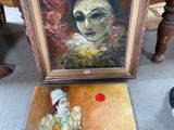 a painting of a clown sitting next to a painting of a clown