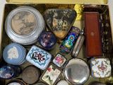 a gold box filled with assorted items on a white surface
