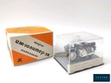 a small toy motorcycle in a clear box on a white surface