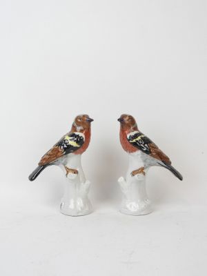 two figurines of birds sitting on top of each other
