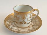 a cup and saucer on a saucer on a white table