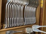 a lot of forks and spoons in a case