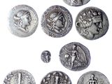 une image représentant un ensemble de pièces d'argent sur lesquelles figurent les portraits d'un homme et d'une femme