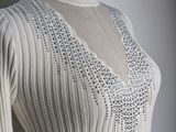 a close up of a white sweater on a mannequin mannequin