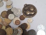 a pile of coins sitting on a table with a coin in the middle of it